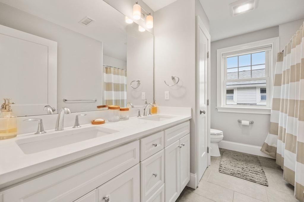 26 Brookfield Road Waltham, MA 02452 - Photo 29 of 37 a bathroom with a sink double vanity and a toilet