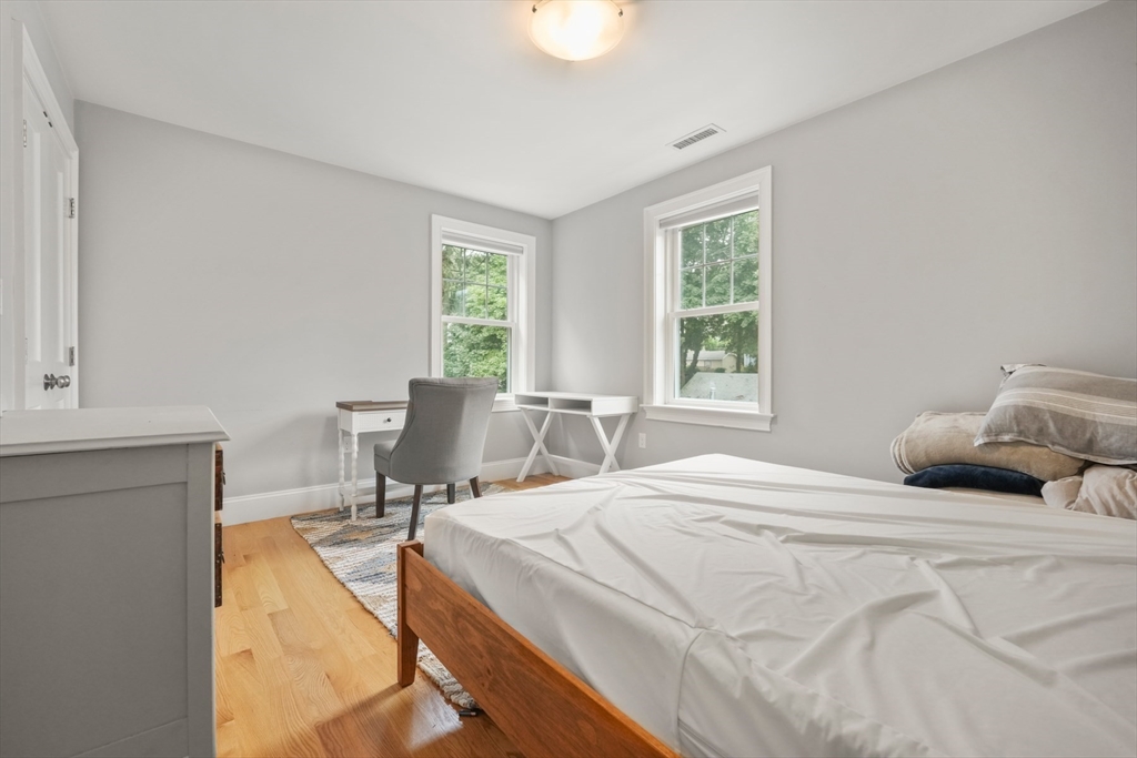 26 Brookfield Road Waltham, MA 02452 - Photo 31 of 37 a bedroom with a bed and large windows