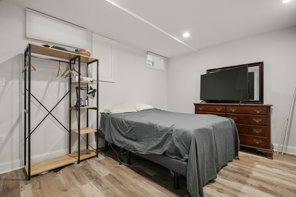 26 Brookfield Road Waltham, MA 02452 - Photo 33 of 37 a bedroom with a bed and a flat screen tv