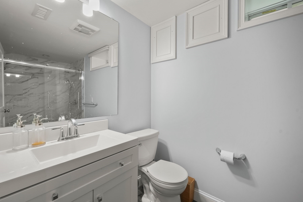 26 Brookfield Road Waltham, MA 02452 - Photo 34 of 37 a bathroom with a sink mirror vanity and toilet