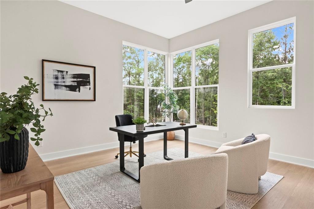 7066 Bells Way Fairburn, GA 30213 - Photo 14 of 64 a living room with furniture and a potted plant
