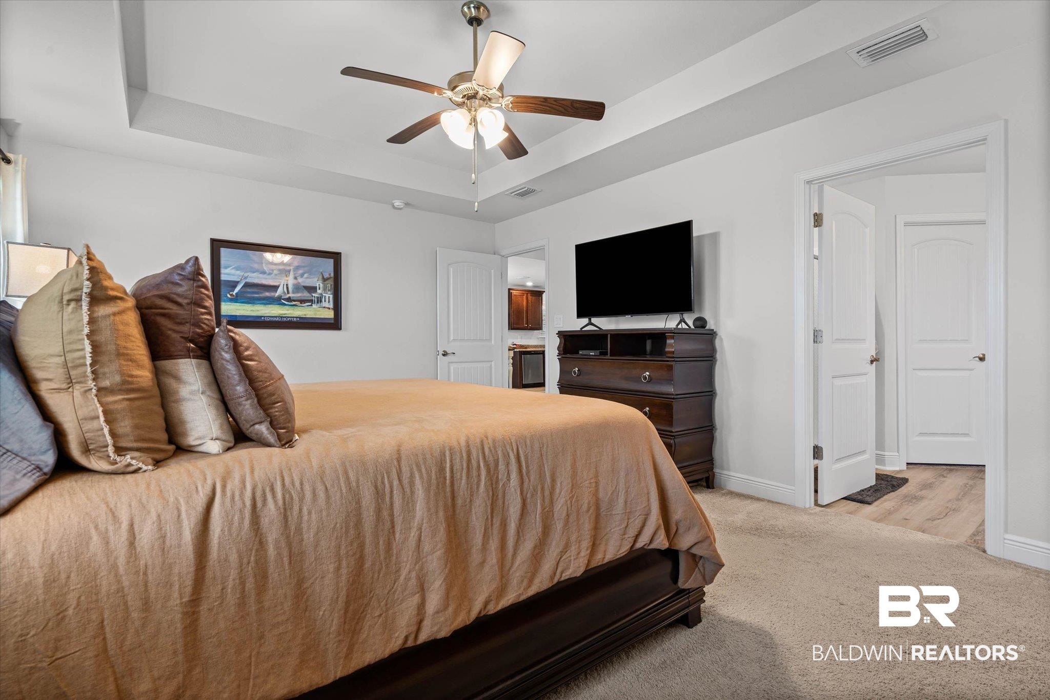 22420 Respite Lane Foley, AL 36535 - Photo 11 of 35 Carpeted bedroom featuring a tray ceiling, ceiling fan with integrated lighting, and white baseboards