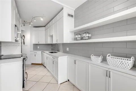 a kitchen with stainless steel appliances granite countertop a sink a stove a microwave and cabinets