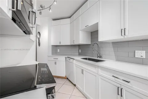 a kitchen with stainless steel appliances a sink stove and cabinets