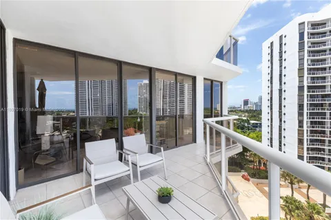a bedroom with a large bed and a large window