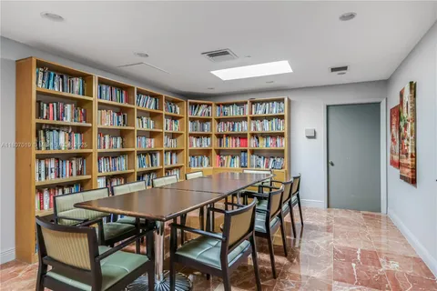 a room with gym equipment and a view of living room