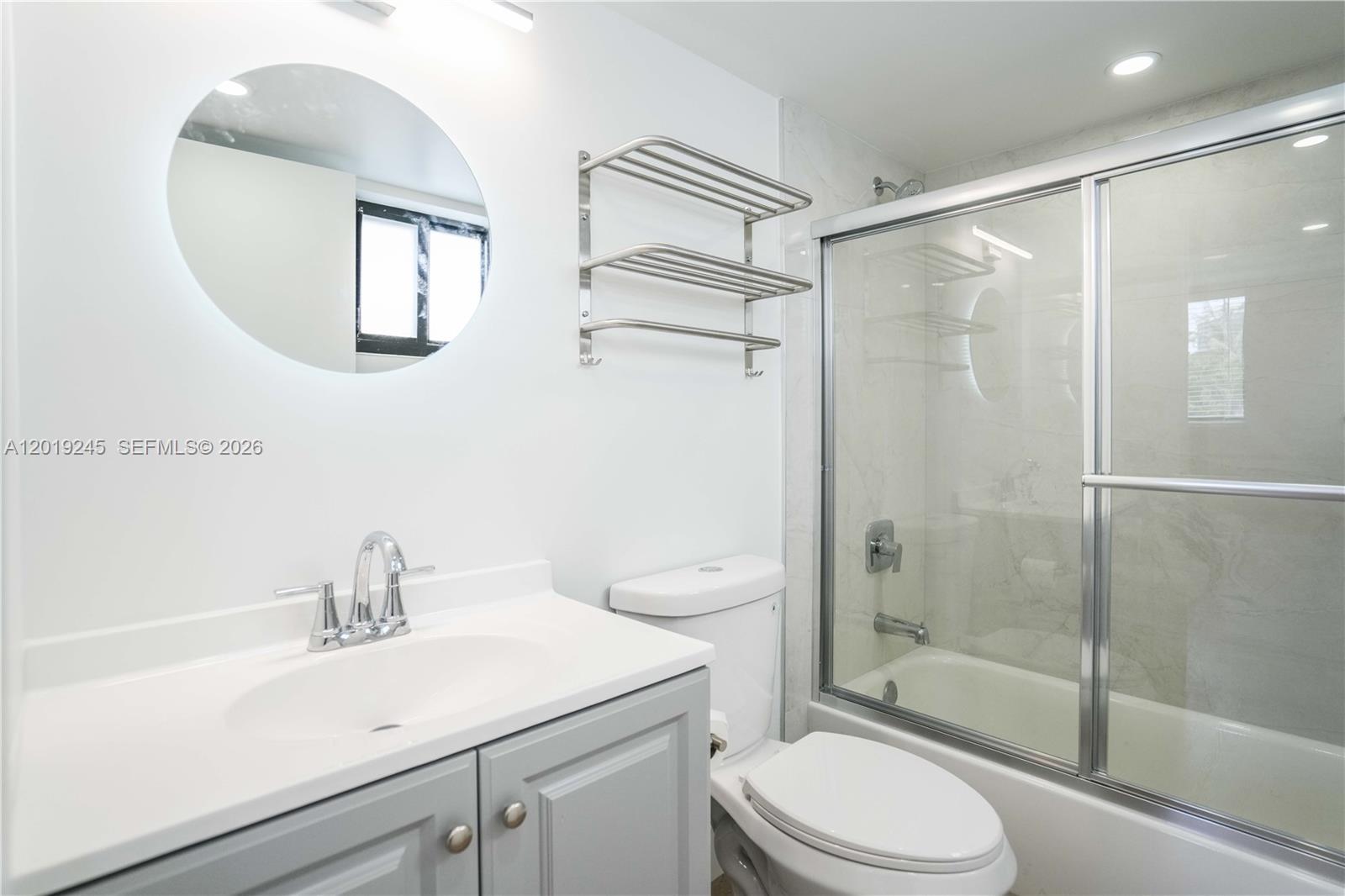 6960 Rue Vendome, Unit 201 Miami Beach, FL 33141 - Photo 12 of 27 a bathroom with a sink a toilet and shower