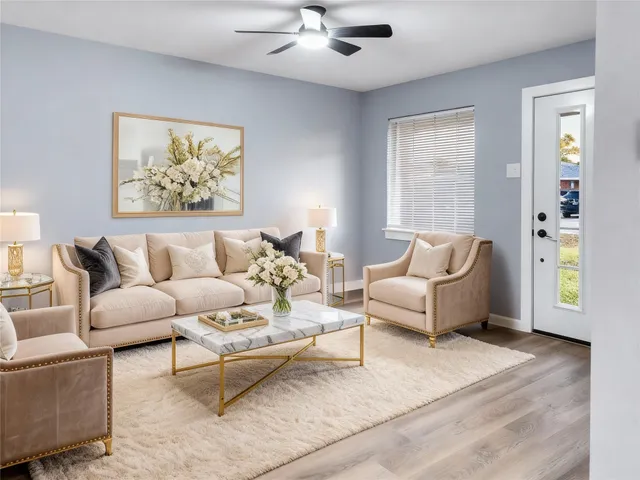 a living room with furniture and a painting on the wall