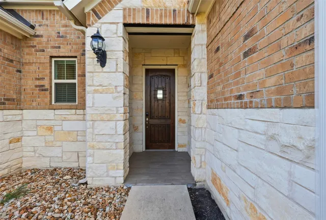 a view of a brick house with a brick wall