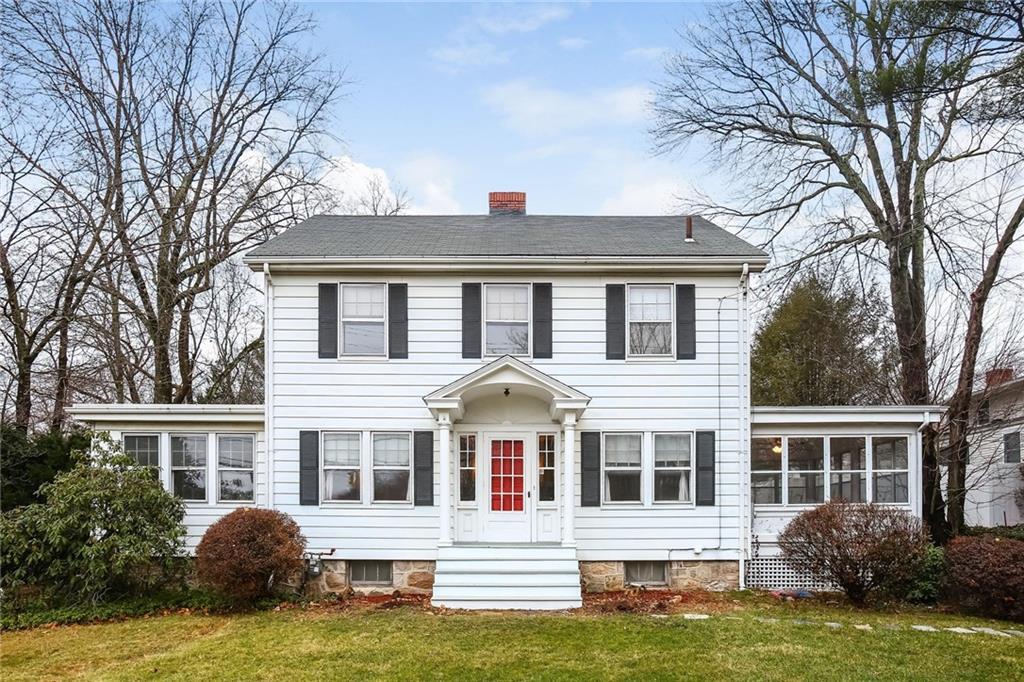 424 High Ridge Road Stamford, CT 06905 - Photo 1 of 1 a front view of a house with a garden and trees