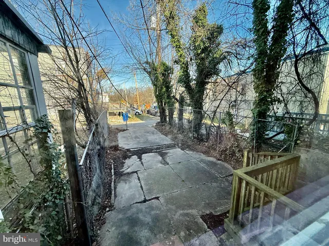 a view of backyard with outdoor seating and trees
