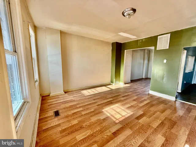 a view of a livingroom with wooden floor and door
