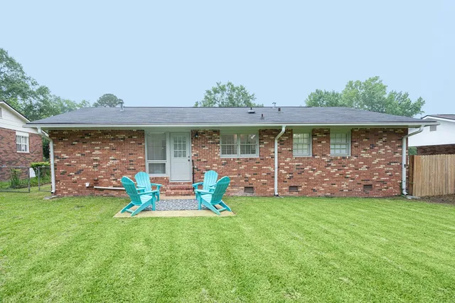 a front view of house with yard and outdoor seating