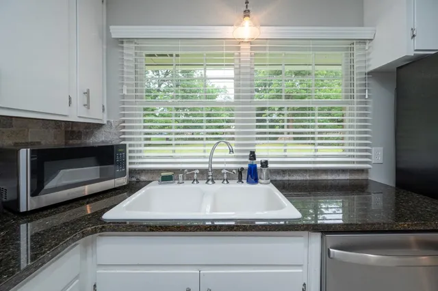 a kitchen with a sink and a microwave