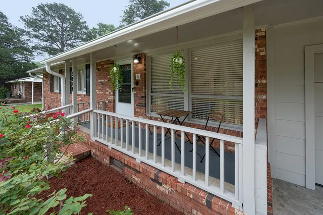 a view of a chair and tables in the balcony