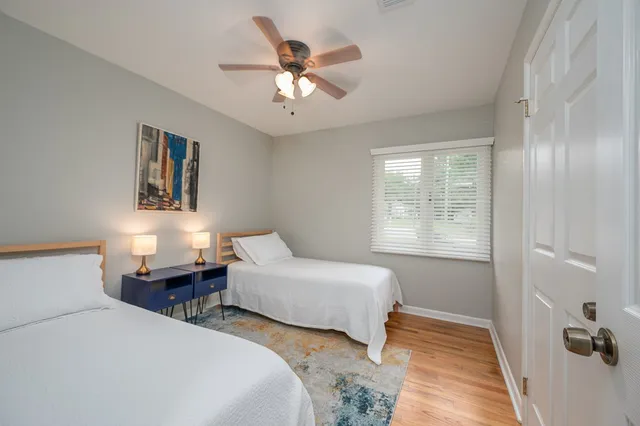 a bedroom with two beds and a chandelier