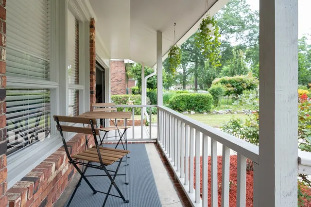 a view of a chairs and table in patio with wooden floor