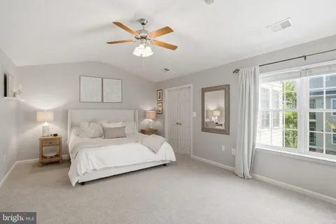 a bedroom with a large bed and a window
