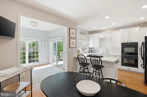 a dining room with furniture a window and wooden floor