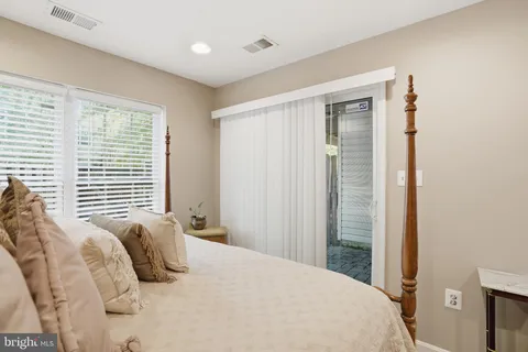 a bedroom with a large bed and a large window