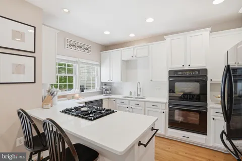 a kitchen with a stove a sink and a refrigerator