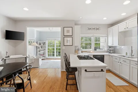 a kitchen with a table chairs sink and cabinets
