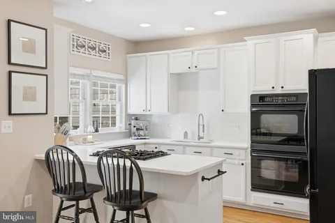 a kitchen that has a sink and a stove top oven