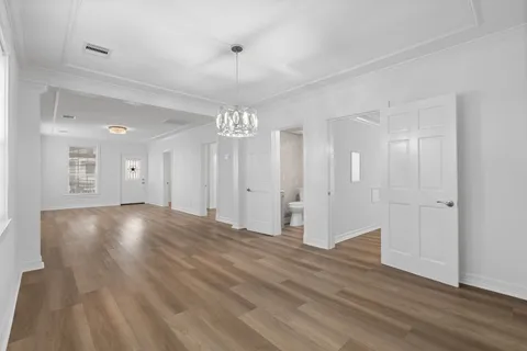 a view of an empty room and wooden floor