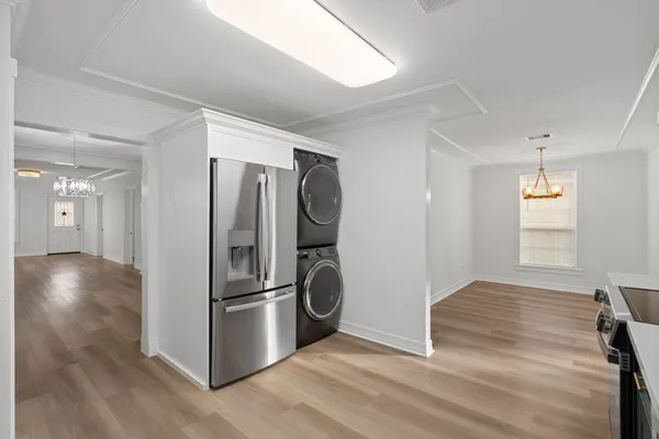 a view of kitchen with refrigerator and wooden floor