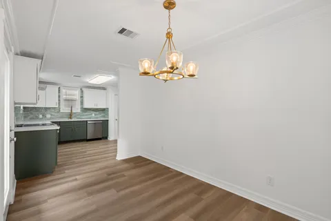 a view of a kitchen with a sink a kitchen counter space and a window