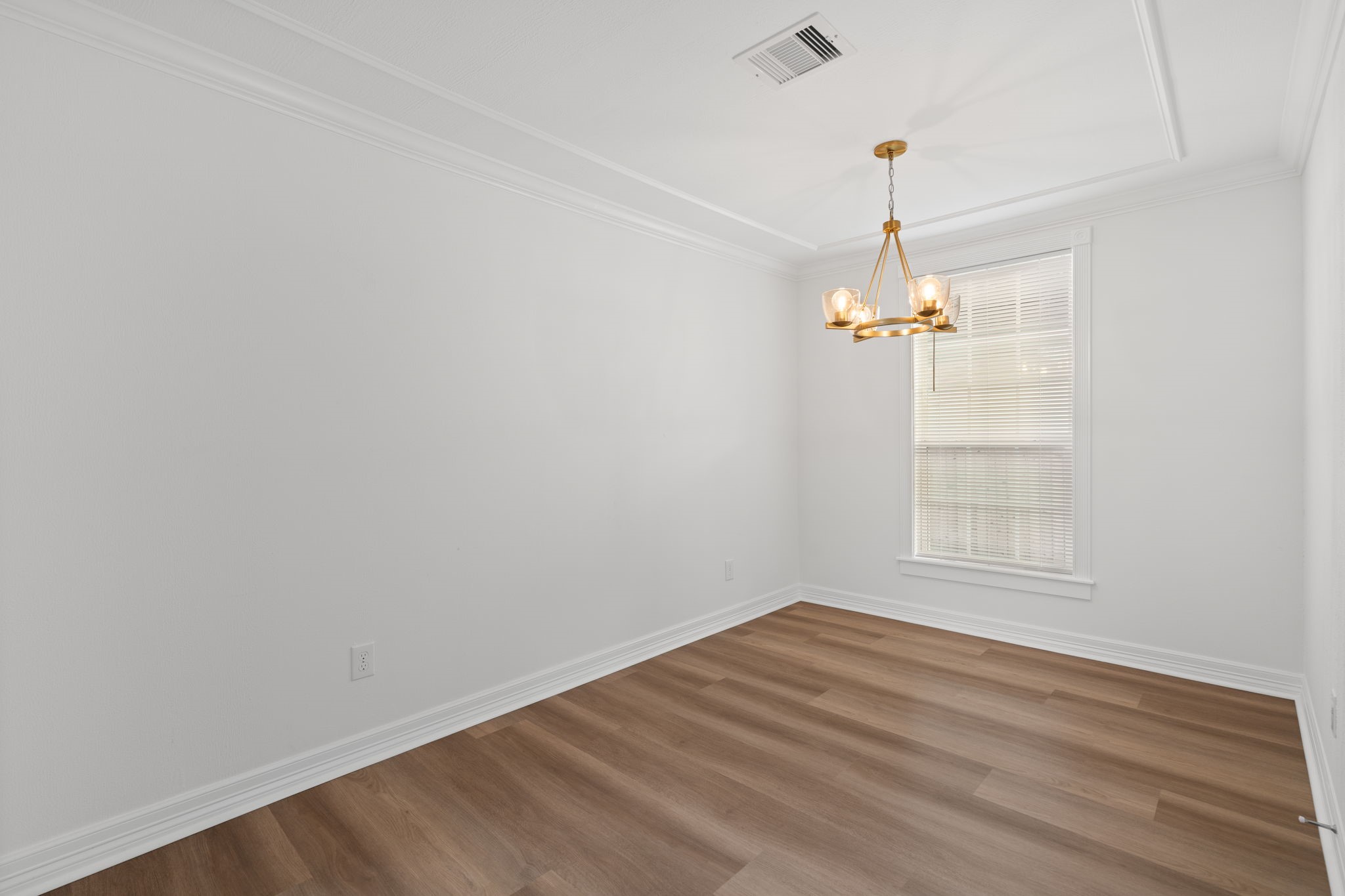 203 Archer Street Houston, TX 77009 - Photo 20 of 43 an empty room with a chandelier fan and windows