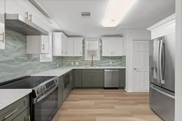 a kitchen with a sink stove and refrigerator