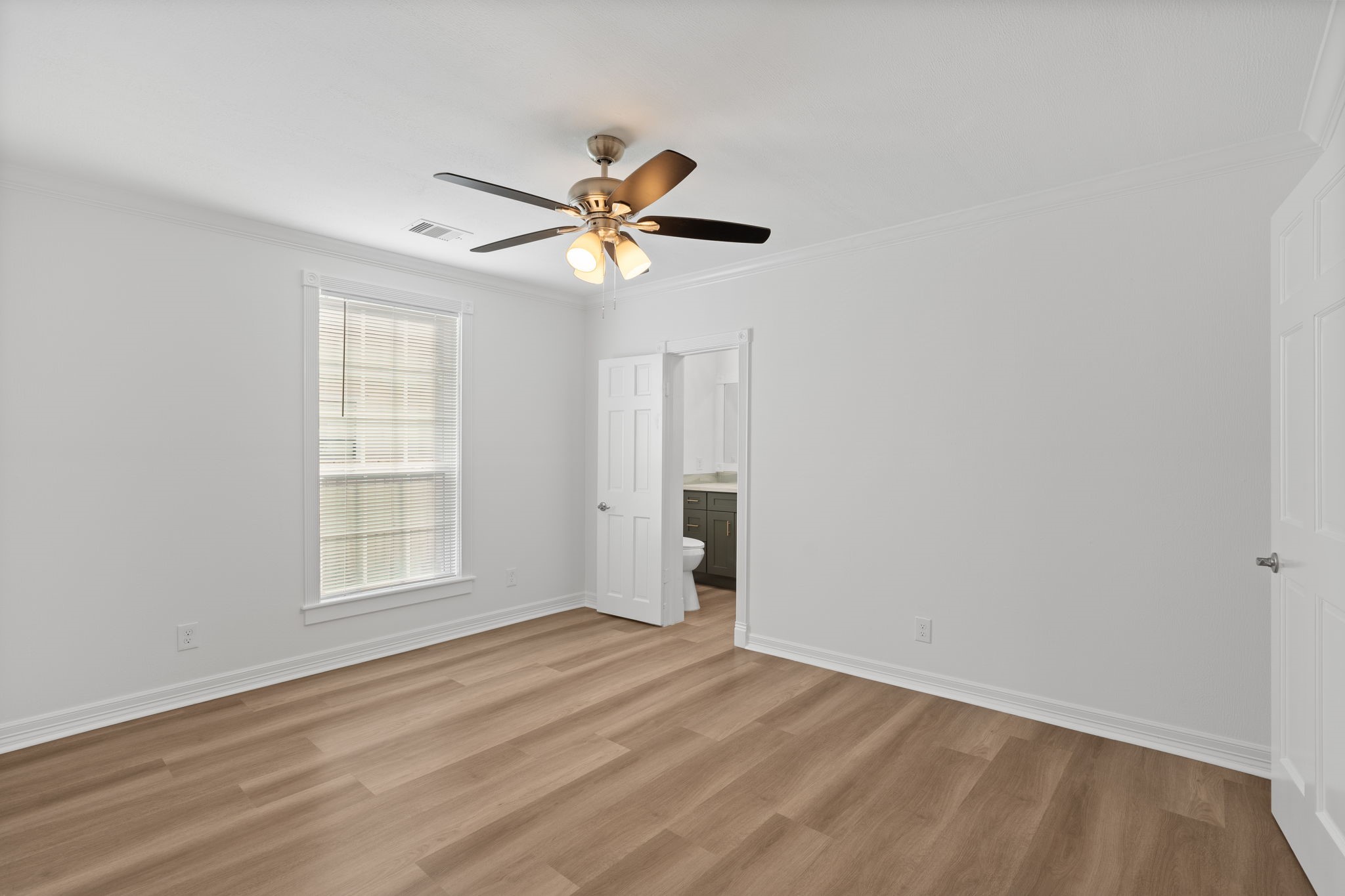 203 Archer Street Houston, TX 77009 - Photo 21 of 43 wooden floor in an empty room with a window