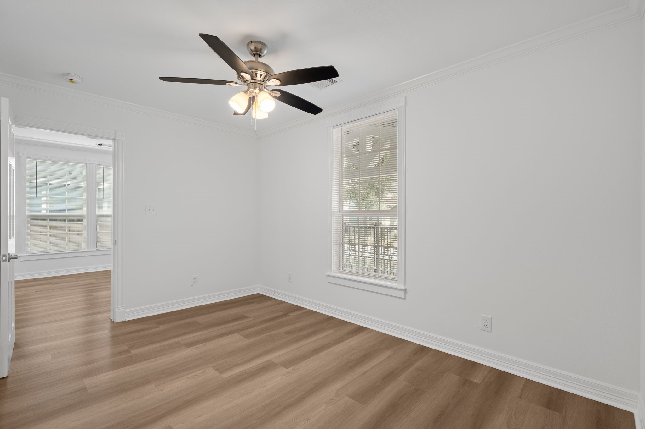 203 Archer Street Houston, TX 77009 - Photo 22 of 43 an empty room with wooden floor fan and windows