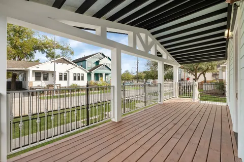 a view of backyard with large trees and wooden floor