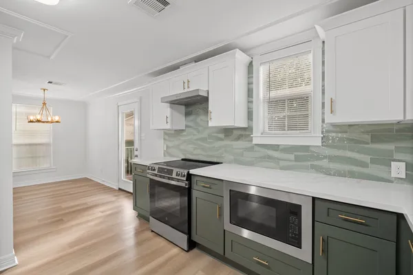 a kitchen with granite countertop a stove and a sink