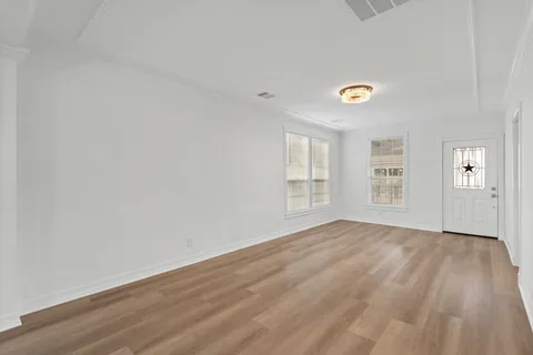 an empty room with windows and closet