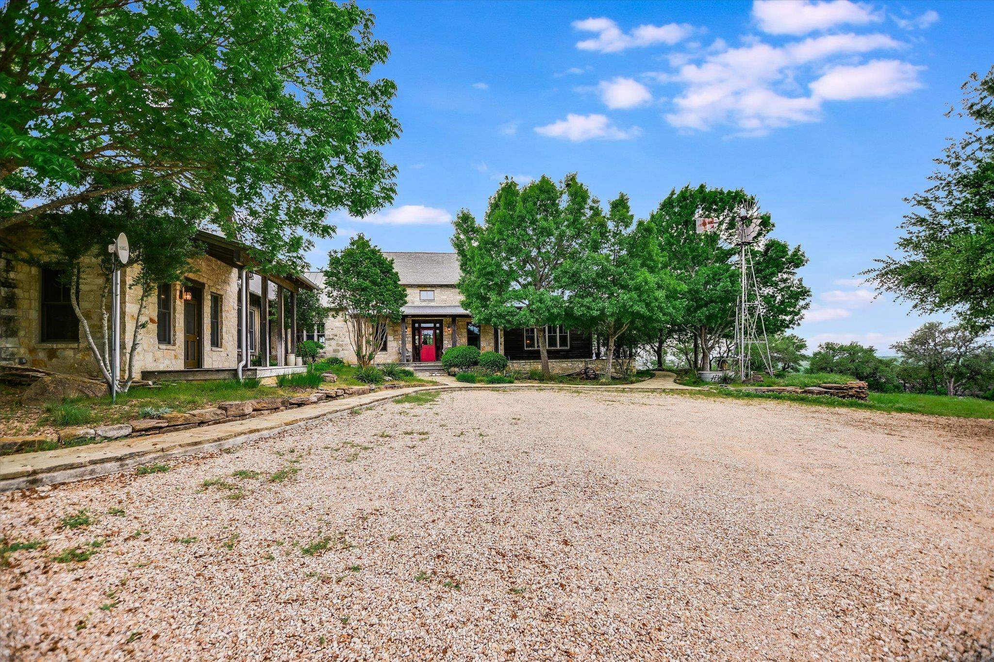 170 Sandstone Ridge Drive Marble Falls, TX 78654 - Photo 2 of 38 a view of a house with garden and trees
