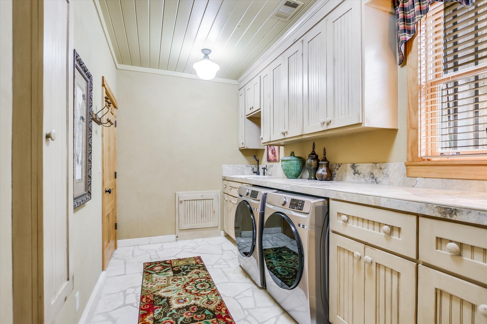 170 Sandstone Ridge Drive Marble Falls, TX 78654 - Photo 21 of 38 a utility room with a sink a washer and dryer