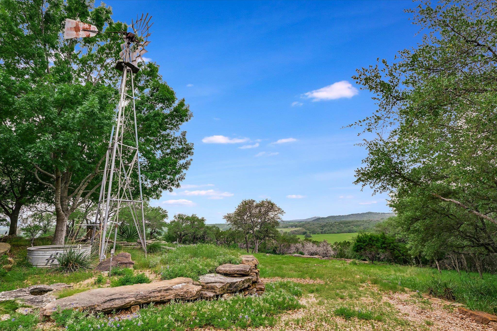 170 Sandstone Ridge Drive Marble Falls, TX 78654 - Photo 29 of 38 a view of a garden with a building in the background