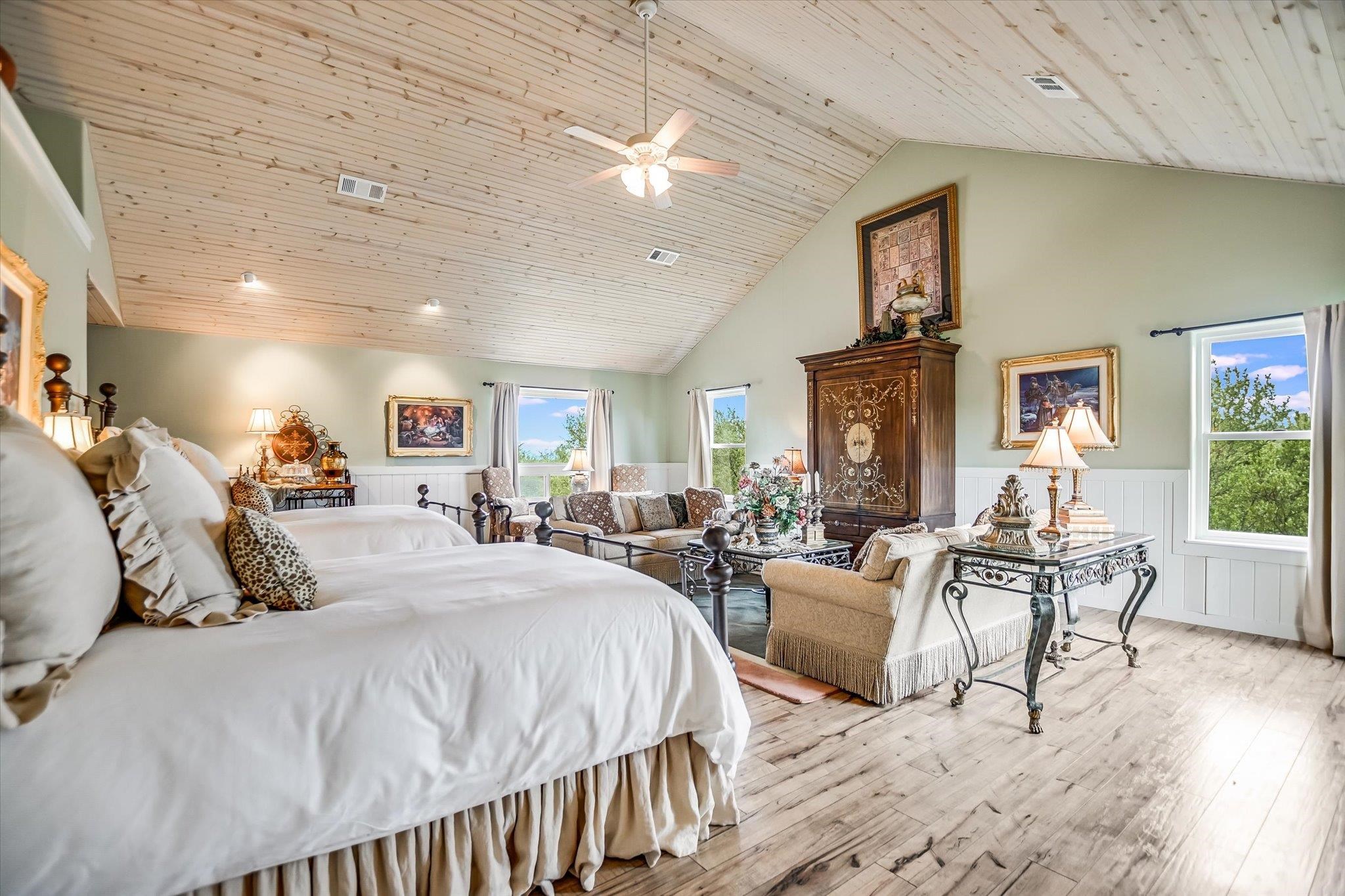 170 Sandstone Ridge Drive Marble Falls, TX 78654 - Photo 33 of 38 a spacious bedroom with a bed a table and chair