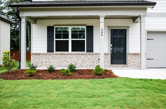 a front view of a house with a yard