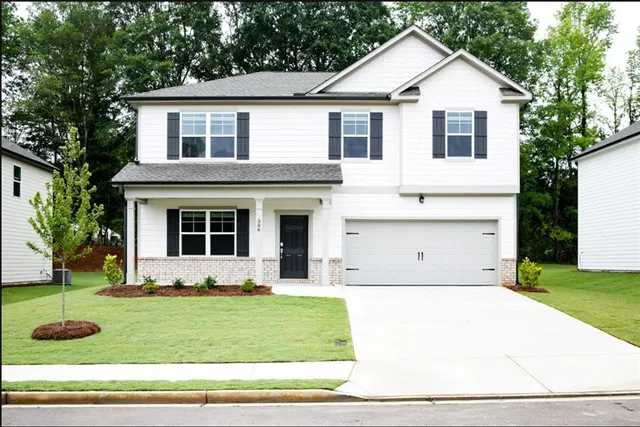 a front view of a house with a yard