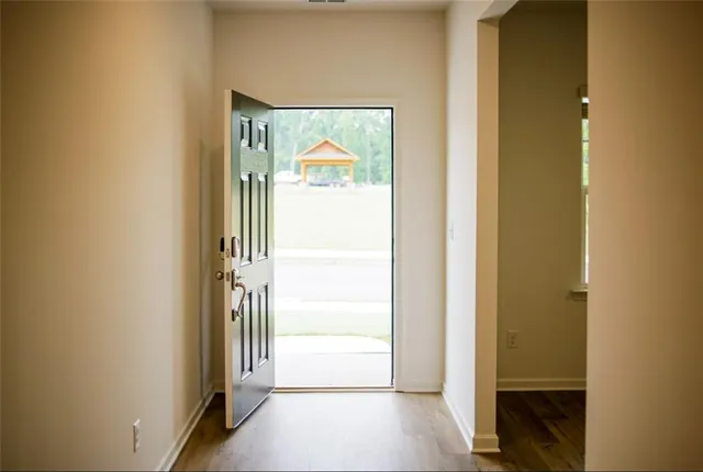 a view of a hallway with wooden floor