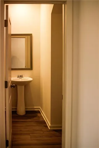 a view of a bathroom with wooden floor and a sink