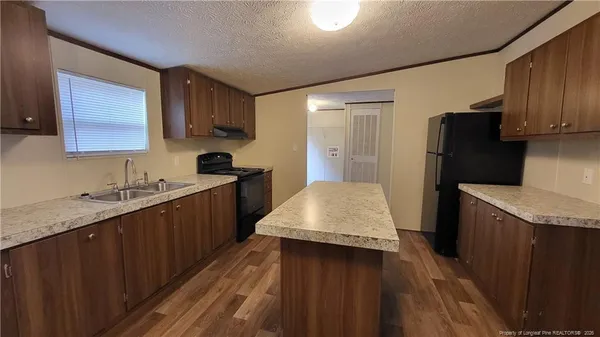 a kitchen with a sink stove and refrigerator