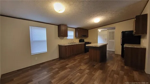 a kitchen with stainless steel appliances granite countertop a sink and a stove top oven
