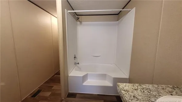 a bathroom with a bathtub and shower
