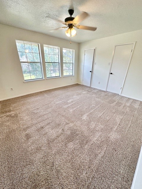 17719 Cassina Drive Spring, TX 77388 - Photo 15 of 19 an empty room with windows and chandelier fan