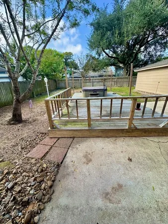 a view of a wooden deck and a yard
